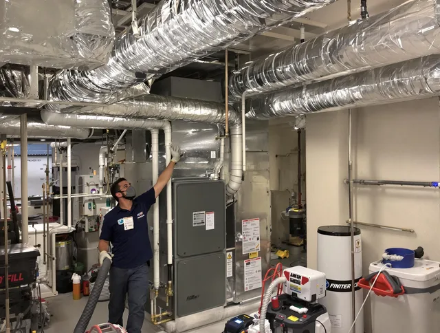 Smithfield Air Duct Cleaning specialist performing thorough furnace duct cleaning in a Smithfield residence